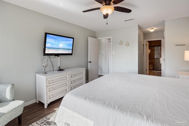 bedroom featuring ceiling fan, visible vents, baseboards, and wood finished floors