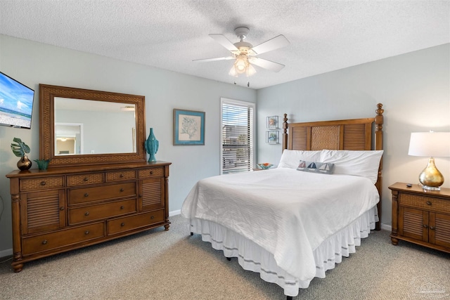 bedroom featuring ceiling fan, carpet flooring, baseboards, and a textured ceiling