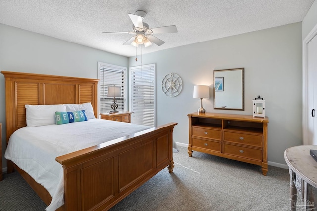 bedroom featuring baseboards, light colored carpet, ceiling fan, and a textured ceiling