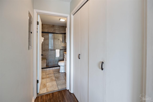 corridor featuring electric panel and dark wood-style floors