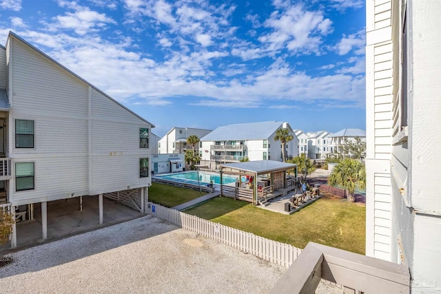 view of pool featuring a yard and a residential view