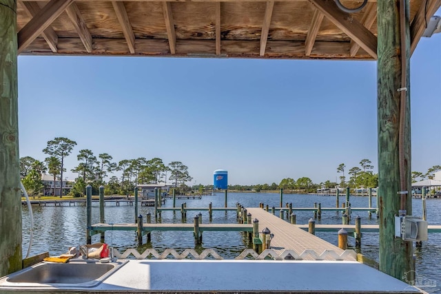 dock area with a sink, a water view, and boat lift