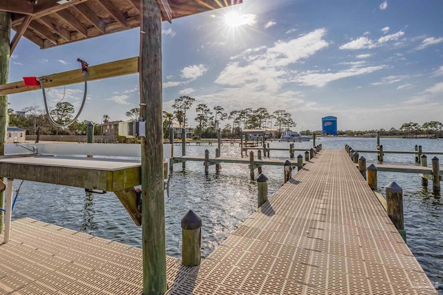 view of dock with boat lift and a water view