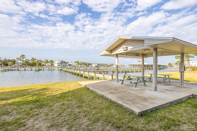 view of community featuring a gazebo, a yard, a water view, and a boat dock