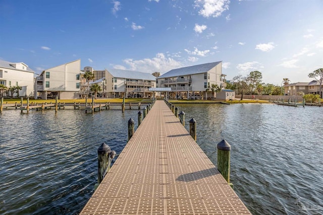 dock area with a residential view and a water view