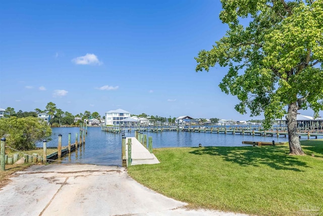 view of dock featuring a yard and a water view