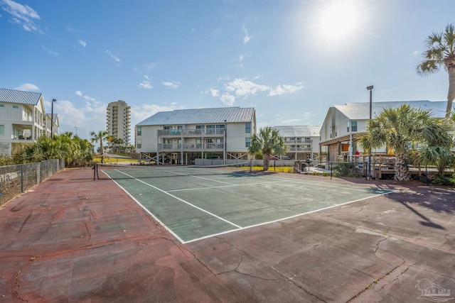 view of tennis court featuring fence