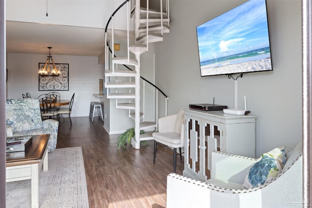 stairs featuring an inviting chandelier, wood finished floors, and baseboards