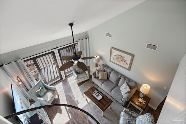 living room featuring ceiling fan, wood finished floors, visible vents, and baseboards