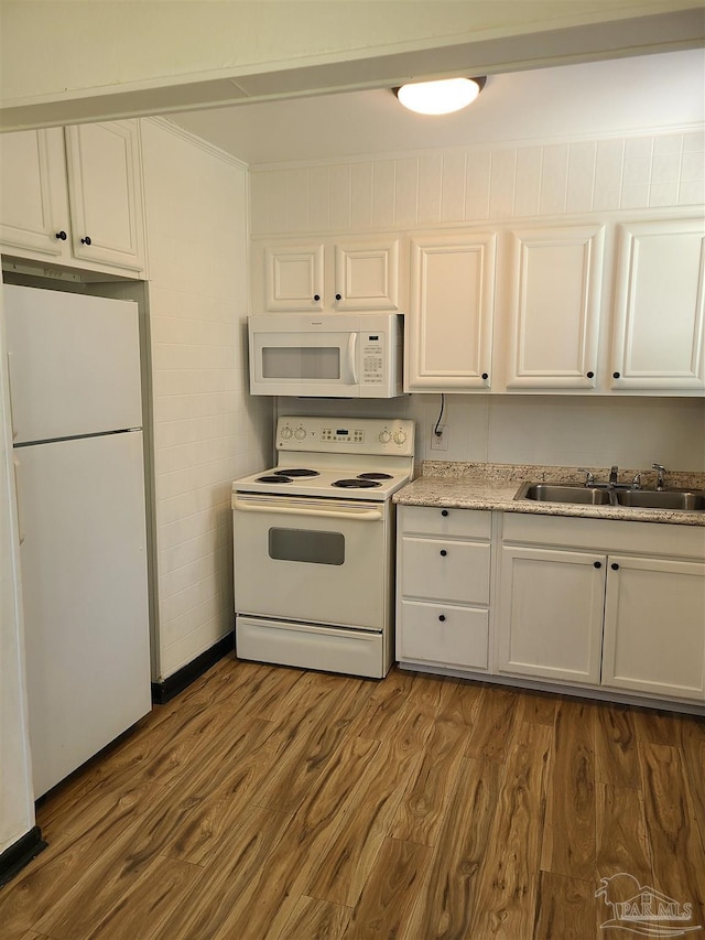 kitchen with white cabinetry, sink, white appliances, and dark hardwood / wood-style flooring