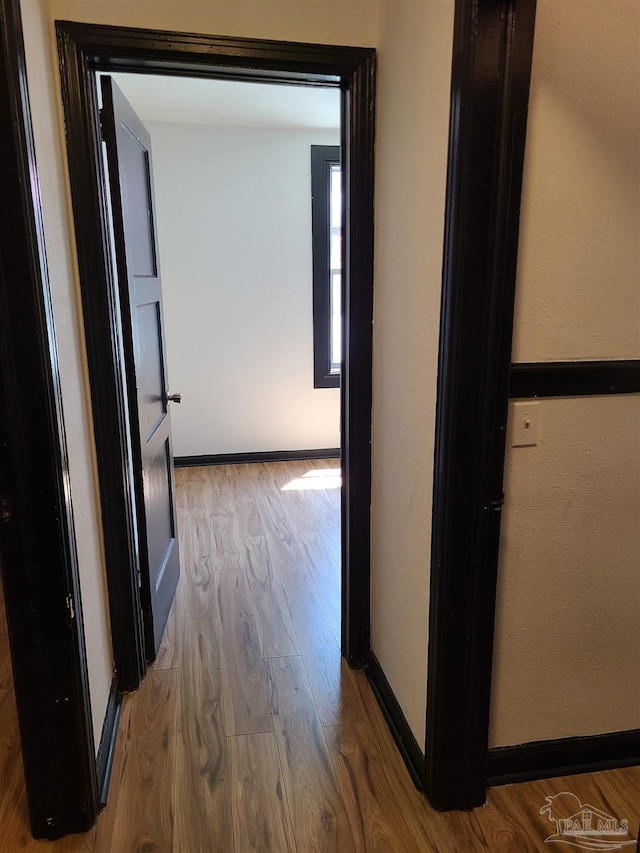 corridor with light hardwood / wood-style flooring