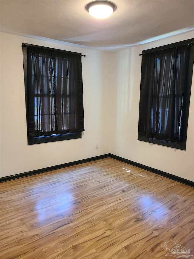 spare room with light wood-type flooring