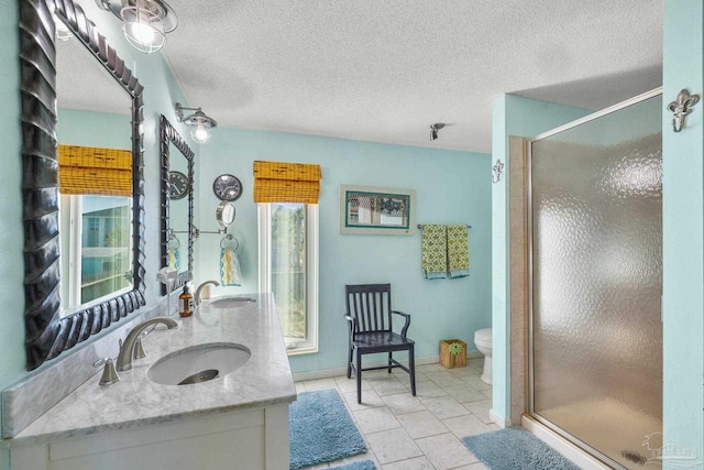 1112 Maldonado Dr, Pensacola Beach, FL 32561 - bathroom featuring vanity, tile patterned flooring, toilet, a textured ceiling, and an enclosed shower