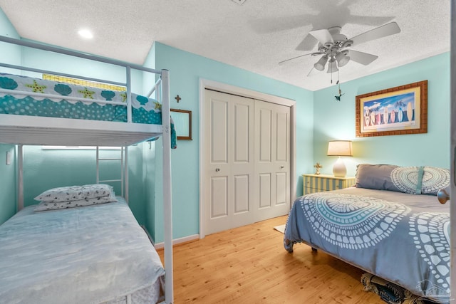 1112 Maldonado Dr, Pensacola Beach, FL 32561 - bedroom with ceiling fan, a closet, a textured ceiling, and light hardwood / wood-style flooring