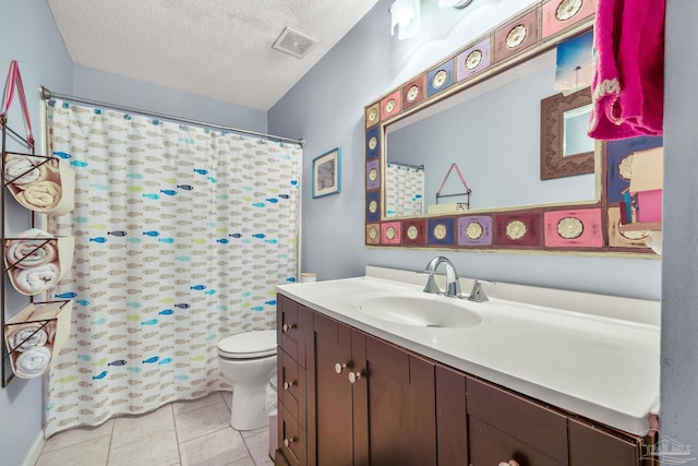1112 Maldonado Dr, Pensacola Beach, FL 32561 - bathroom with tile patterned flooring, vanity, toilet, and a textured ceiling