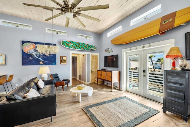 1112 Maldonado Dr, Pensacola Beach, FL 32561 - living room with french doors, wood ceiling, ceiling fan with notable chandelier, and light hardwood / wood-style flooring
