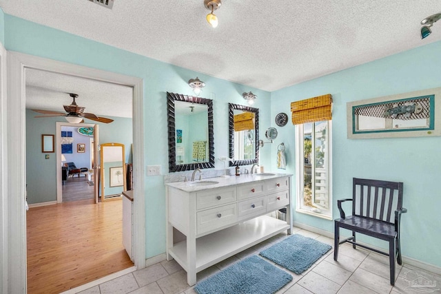 1112 Maldonado Dr, Pensacola Beach, FL 32561 - bathroom with tile patterned flooring, vanity, a textured ceiling, and ceiling fan