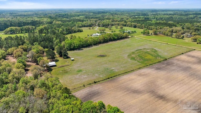 bird's eye view featuring a wooded view and a rural view