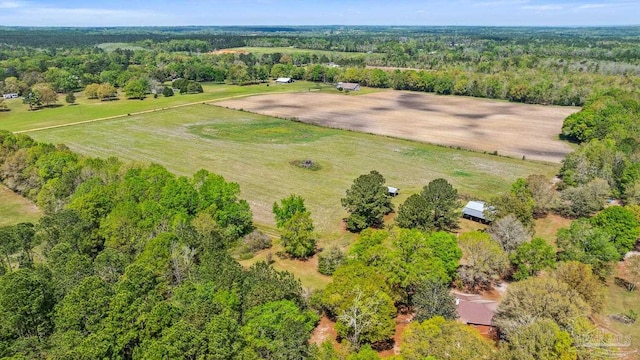 birds eye view of property featuring a wooded view and a rural view