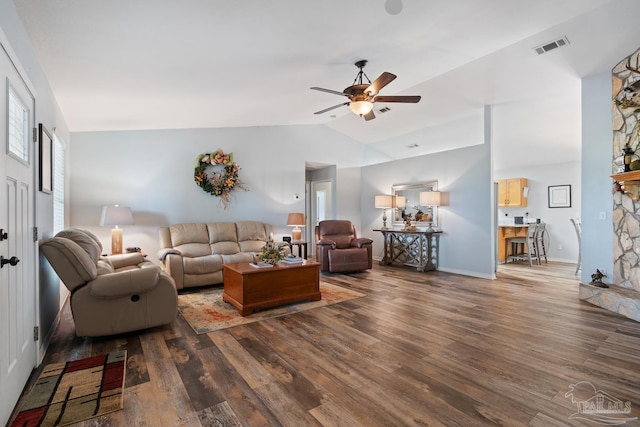 living area featuring vaulted ceiling, baseboards, visible vents, a ceiling fan, and wood finished floors