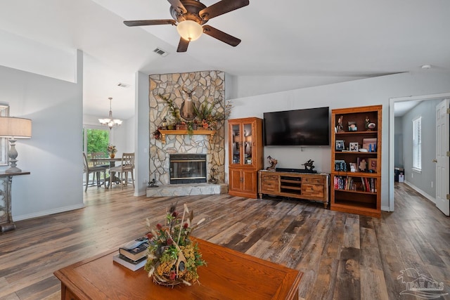 living room featuring dark wood finished floors, ceiling fan with notable chandelier, visible vents, and lofted ceiling