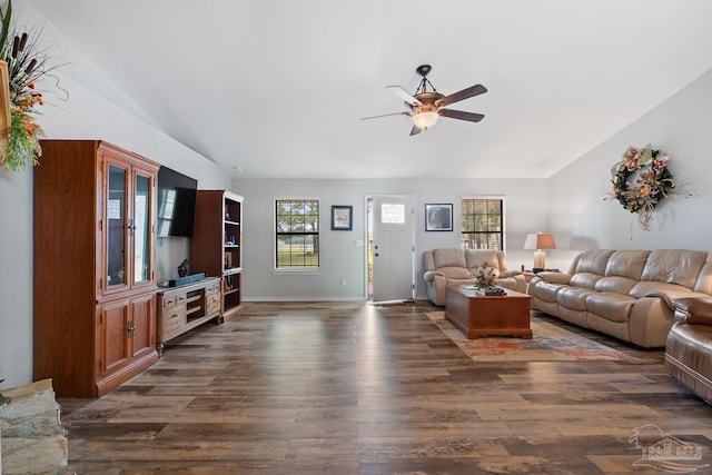 living room featuring dark wood-style floors, ceiling fan, vaulted ceiling, and plenty of natural light