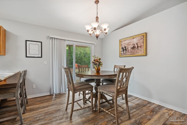 dining area with dark wood-type flooring, baseboards, and a chandelier