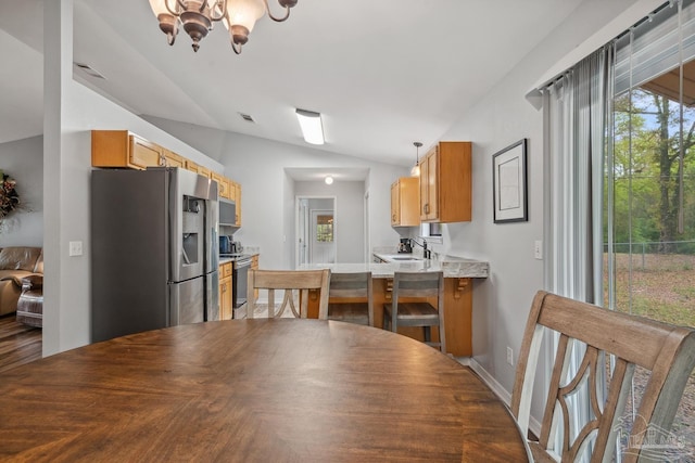 dining area featuring a notable chandelier, baseboards, vaulted ceiling, and visible vents