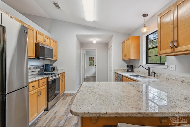 kitchen featuring a sink, visible vents, light stone counters, and appliances with stainless steel finishes