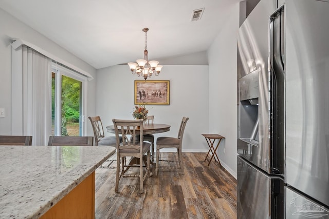 dining room featuring lofted ceiling, baseboards, a chandelier, dark wood finished floors, and visible vents