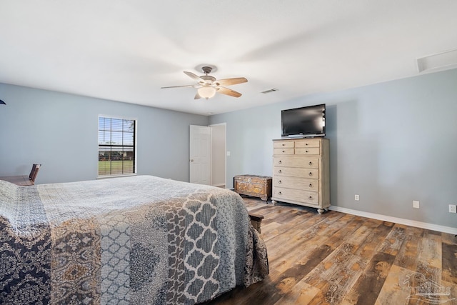 bedroom featuring wood finished floors, baseboards, ceiling fan, and visible vents