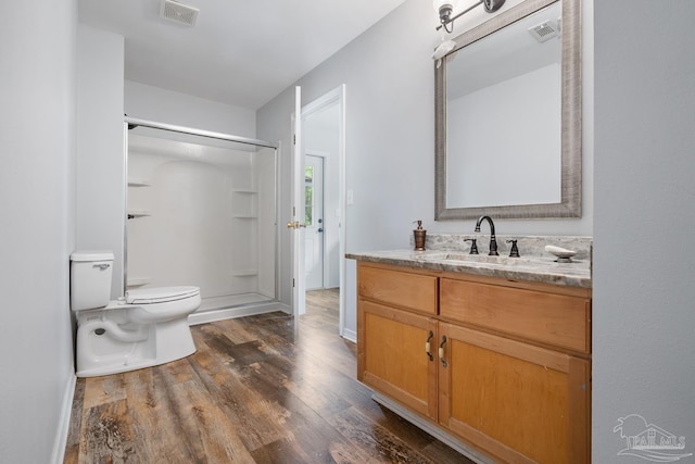 full bathroom featuring a shower stall, visible vents, wood finished floors, and toilet
