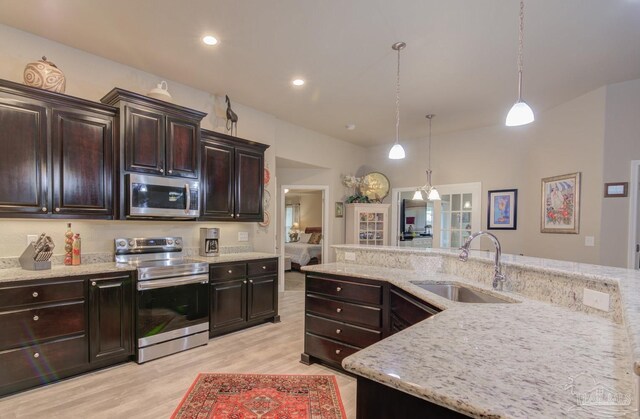 entrance foyer with french doors, an inviting chandelier, and light hardwood / wood-style flooring