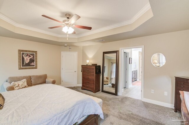 bedroom with crown molding, light colored carpet, a raised ceiling, and ceiling fan