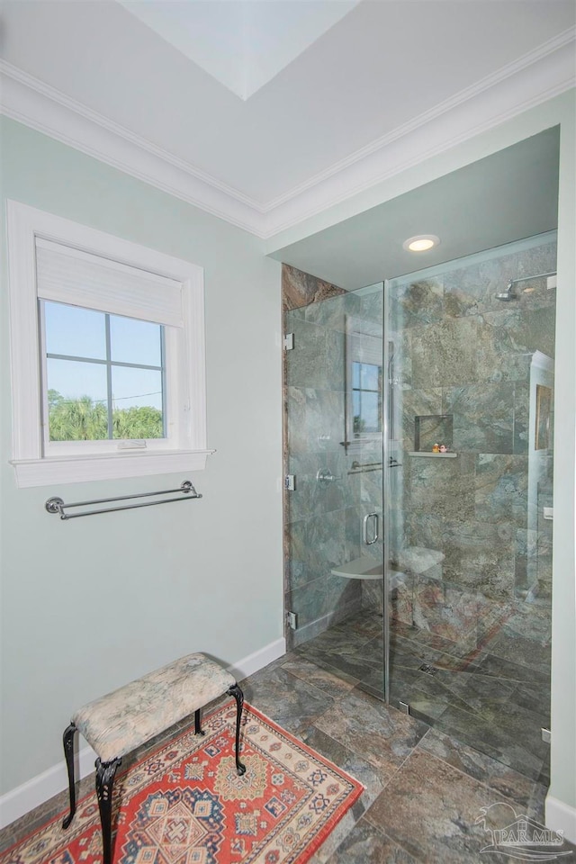 bathroom with a shower with door and ornamental molding