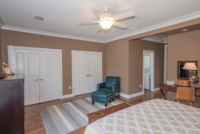 bedroom with crown molding, two closets, wood-type flooring, and ceiling fan