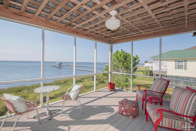 sunroom / solarium featuring a water view and a healthy amount of sunlight