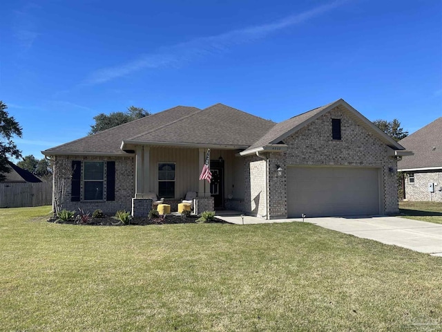 view of front of home with a front yard and a garage