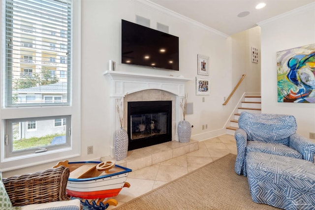 tiled living room with ornamental molding and a tiled fireplace