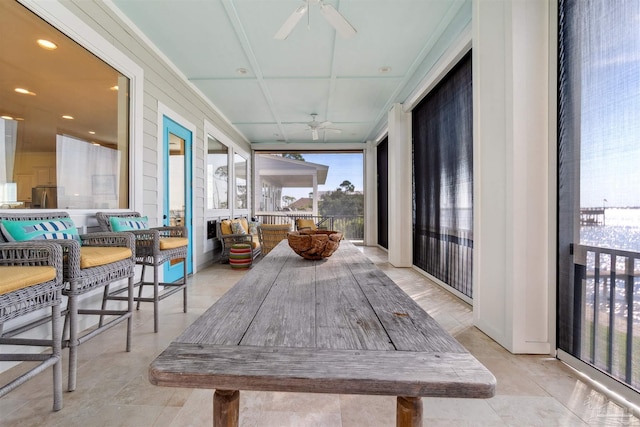 sunroom featuring ceiling fan and a wealth of natural light