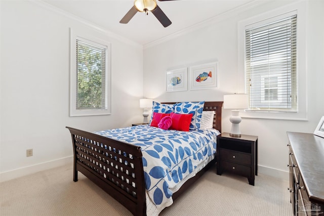 bedroom featuring ceiling fan, light colored carpet, and crown molding