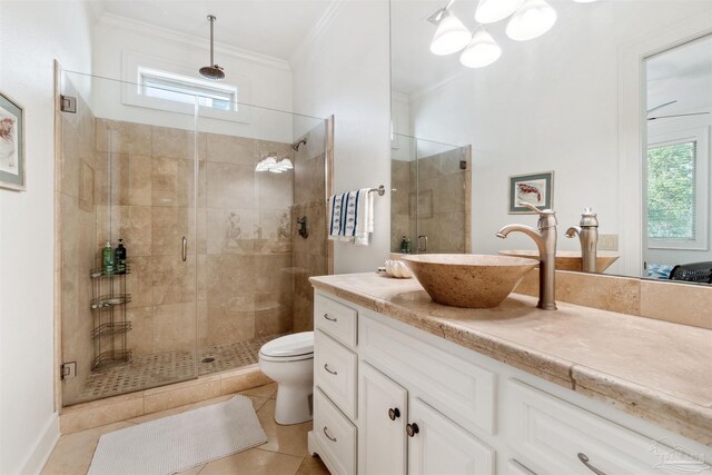 bathroom with vanity, crown molding, tile patterned flooring, toilet, and an enclosed shower