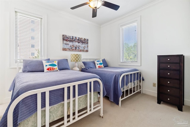 carpeted bedroom with ceiling fan and crown molding