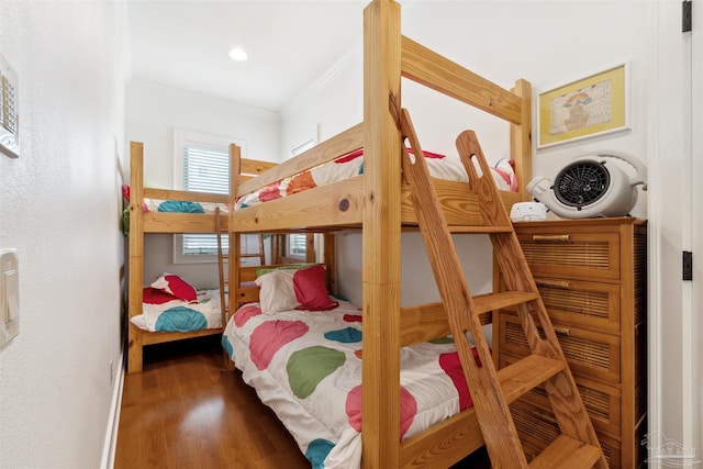 bedroom featuring ornamental molding and dark hardwood / wood-style flooring