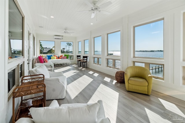 sunroom / solarium featuring ceiling fan, wood ceiling, a water view, and a wall unit AC