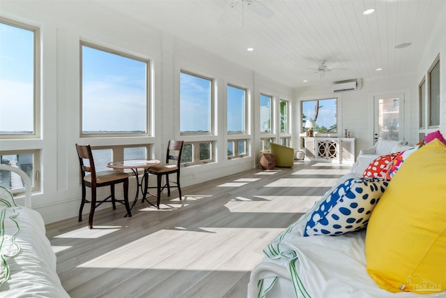 sunroom with ceiling fan and a wall unit AC