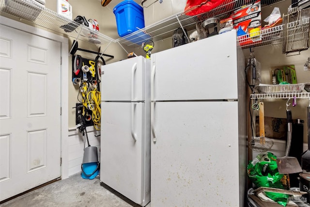 kitchen with concrete floors and white refrigerator