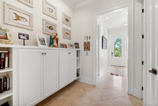 corridor with light tile patterned floors and ornamental molding