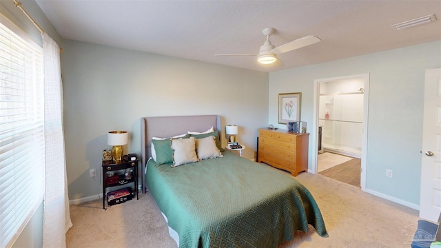 bedroom featuring baseboards, ceiling fan, visible vents, and connected bathroom