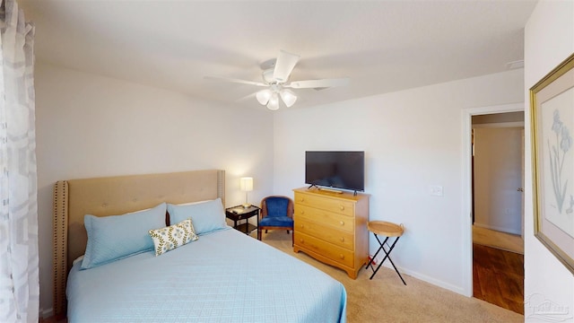 carpeted bedroom featuring ceiling fan and baseboards